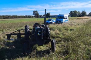 Ciągnik, w tle radiowozy